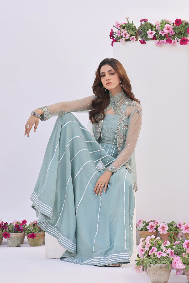  Dive into celestial allure with AASMANI This stunning ensemble features a kora net jacket adorned with exquisite diamante handwork and beauty.