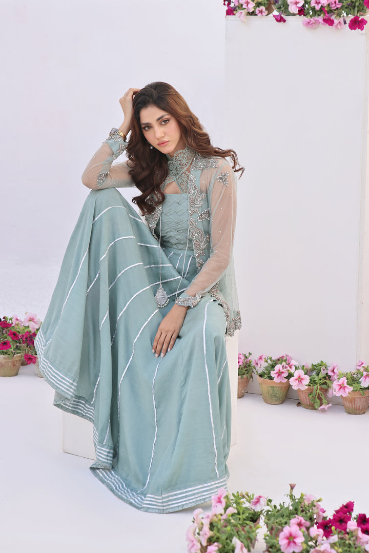  Dive into celestial allure with AASMANI This stunning ensemble features a kora net jacket adorned with exquisite diamante handwork and beauty.