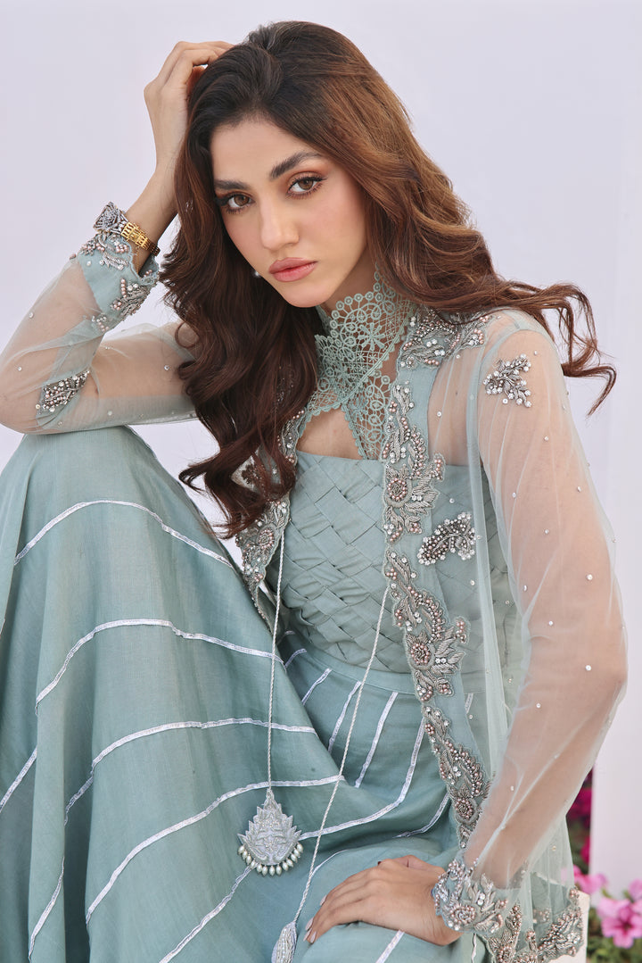  Dive into celestial allure with AASMANI This stunning ensemble features a kora net jacket adorned with exquisite diamante handwork and beauty.